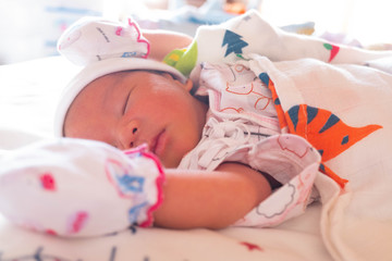 The Sleeping cute New Born Baby infant on the bed