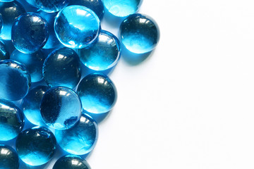 Blue glass spheres on white background. Closeup macro abstract