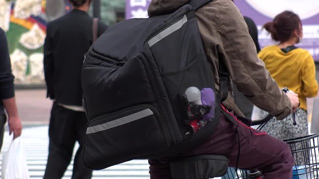 TOKYO, JAPAN : Close up shot of food delivery bag at the street. Large black box backpack to carry food or drinks from restaurant and cafe to customers.