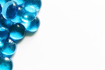 Blue glass spheres on white background. Closeup macro abstract