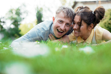 Couple in love. Happy couple lying on grass. Honeymoon. Love photo. 