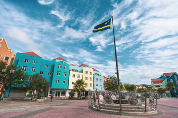flag of Caribbean island Curacao on the old town square - obrazy, fototapety, plakaty