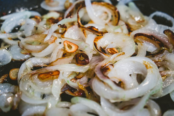 Fried onions and garlic in oil in a pan.