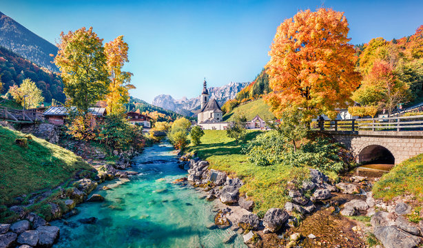 Vivid morning scene of Parish Church of St. Sebastian. Colorful autumn view of Bavarian Alps, Au village location. Bright outdoor scene of Germany countryside, Europe. Traveling concept background..