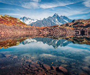 High Alps mountain feflected in cflm water of Chesery lake/Lac De Chesery, Chamonix location. Nice outdoor scene of Vallon de Berard Nature Preserve, Graian Alps, France, Europe.