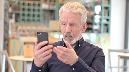 Portrait of Loss on Smartphone by Old Man