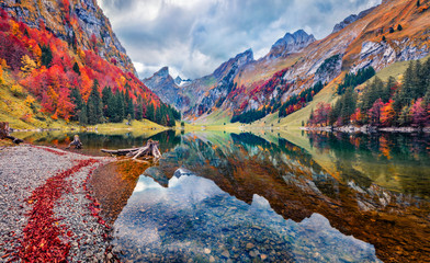 Gloomy morning view of Seealpsee lake. Astonishing autumn scene of Swiss Alps. Majestic Santis peak...