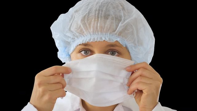 Wear the mask! Female doctor wearing a mask and pointing her finger up, Alpha Channel