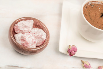 turkish delights and coffee on table with roses