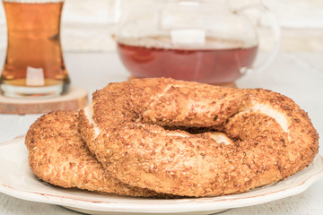Simit that is Turkish bagel and tea on a wooden table