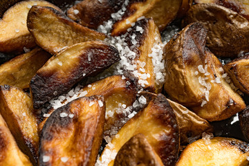 Close-up of baked or fried potatoes. Rustic style.