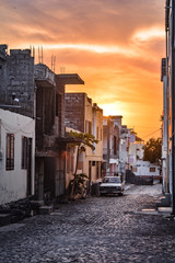 Sunset among the buildings in the streets of the small village of Vila do Maio