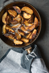Close-up of baked or fried potatoes. Rustic style.