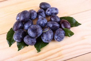 Black plums on table