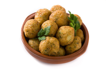 Traditional cod fritters in clay bowl isolated on white background
