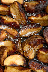 Close-up of baked or fried potatoes. Rustic style.
