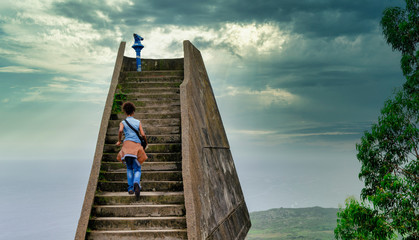 Black woman going upstairs in the Boriza viewpoint. Andrín Beach, Llanes, Asturies, Spain
