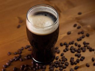 stout or porter with coffee on a wooden pub table