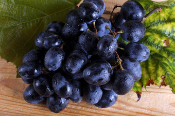 Grape and leaves on table
