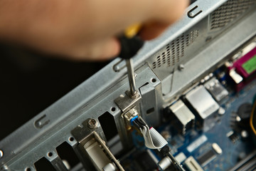 Fototapeta na wymiar A technician repairing a desktop computer. This image has selective focus. 