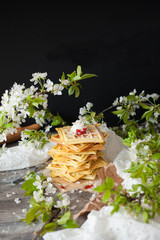 crispy homemade healthy viennese waffles with ice cream and jam. spring flowering, cherry or cherry flowers. home decor and comfort