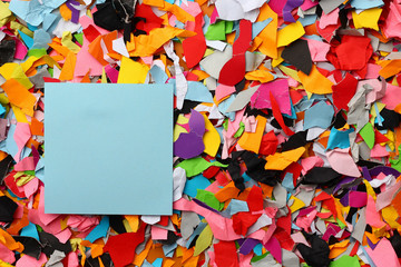 Blank sticker with place for text on background of torn colored paper