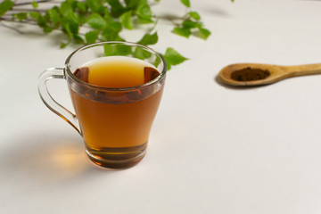 Chaga powder tea in a transparent cup. Horizontal orientation.