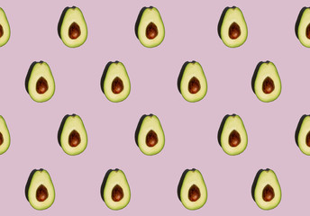 Avocado pattern isolated on purple background. Fresh. Vegetables. Food photo. 