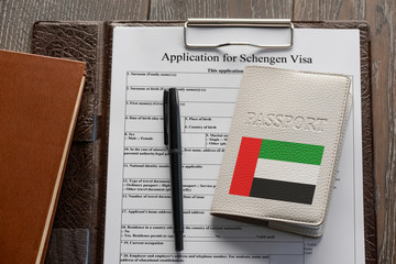 Application form, pen and a United Arab Emirates passport