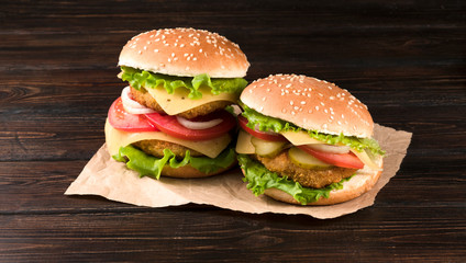 .two hamburgers on a wooden background