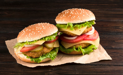 .two hamburgers on a wooden background
