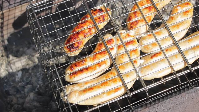 Kupaty sausages on a grill. Kupaty made from chicken and pork, intestines, pepper, onions and other spices. 
Stay home with family and cook barbecue during May holidays and the coronavirus pandemic