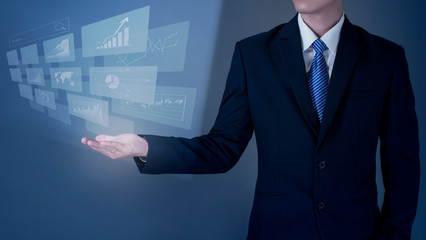 Close up Business man is holding digital virtual screen, analytics financial data