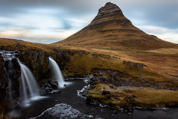 Kirkjufell mountain and waterfall at sunset.