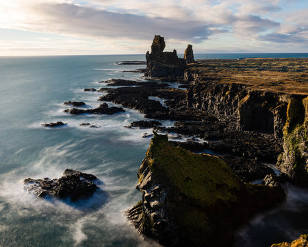 Basalt Rock cliffs fall away into the calm sea below. Taken from Iceland&rsquo;s, Snafellsnes peninsula on a clear blue sky day. 