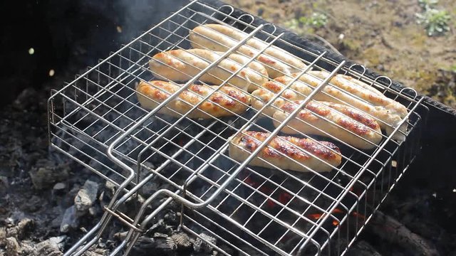 Kupaty sausages on a grill. Kupaty was made from chicken and pork, intestines, pepper, onions and other spices. Stay home with family and cook barbecue during May holidays and the coronavirus pandemic