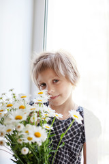 pretty little girl with   bouquet of daisies