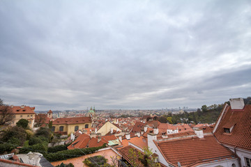 Fototapeta na wymiar Panorama of Prague, Czech Republic, seen from the top of the castle, during an autumn cloudy afternoon. Major tourist landmarks such as medieval towers, cathedrals and churches, are visible
