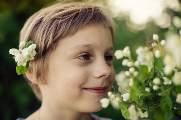 Portrait of   short-haired little girl in nature