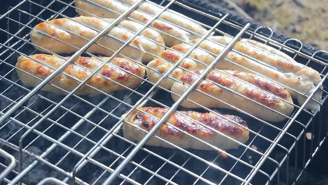 Kupaty sausages on a grill. Kupaty was made from chicken and pork, intestines, pepper, onions and other spices. Stay home with family and cook barbecue during May holidays and the coronavirus pandemic
