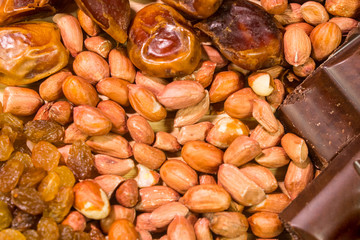 Raisins, dried apricots close-up, Oriental texture sweets. Chocolate