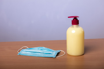 antiseptic bottle and a medical mask to fight microbes and viruses. hand washing. hygiene. the...