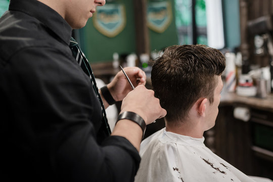 The process of cutting a man in a barbershop