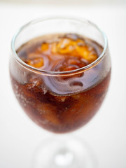 Cola soft drinks are in the glass.
have Drop of water Glass round,White Background