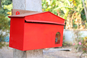 red mailbox on a fence