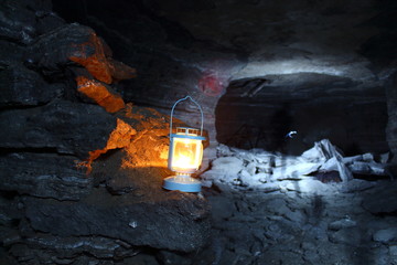 a lantern shines in a cave