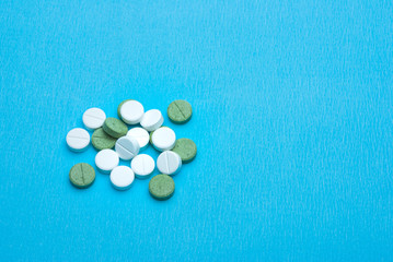 Fototapeta na wymiar white and green tablet on a blue background