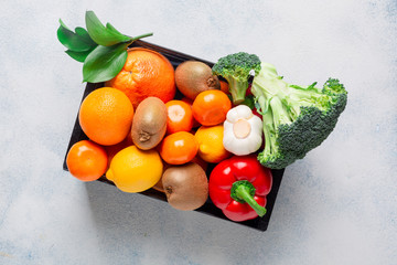 A variety of products, vegetables and fruits to maintain immunity in a black box on a white background