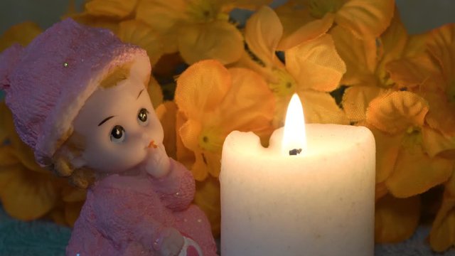 doll and burning candle,toy doll by candlelight at night, tragedy candle burning, memory of children