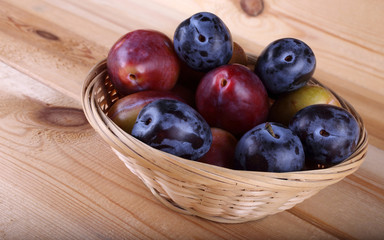 Different color plums on table